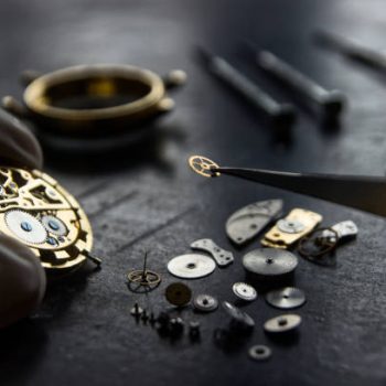 Professional watch repair technician fixing a luxury watch at Busy Bee Jewelry in Massapequa, NY